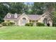Charming brick home featuring manicured lawn and mature trees in a desirable neighborhood at 3 Bent Oak Ct, Durham, NC 27705