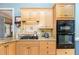 Bright kitchen featuring granite countertops, stainless steel appliances, and light wood cabinets at 3 Bent Oak Ct, Durham, NC 27705