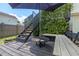 Close up view of back deck with a shade umbrella, greenery wall, and bar seating at 309 S Haywood St St, Raleigh, NC 27601