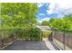 View of the back deck featuring an ivy wall, trees and a nearby house at 309 S Haywood St St, Raleigh, NC 27601