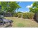 Private backyard featuring a small deck, grassy area, and mature trees for shade and privacy at 309 S Haywood St St, Raleigh, NC 27601
