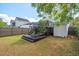 View of backyard featuring a raised deck, grass, a shed and a blue umbrella at 309 S Haywood St St, Raleigh, NC 27601