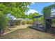 View of backyard featuring a raised deck, grass, greenery, a blue umbrella and a fence at 309 S Haywood St St, Raleigh, NC 27601