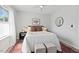 Stylish bedroom with ceiling fan, large window, and warm-toned accent pillows at 309 S Haywood St St, Raleigh, NC 27601