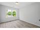 Well-lit bedroom featuring neutral walls, wood flooring, and a large window for ample natural light at 309 S Haywood St St, Raleigh, NC 27601