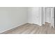Empty bedroom featuring neutral walls, wood flooring, a closet, and minimalist trim at 309 S Haywood St St, Raleigh, NC 27601