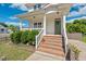 Inviting front entrance with brick steps, a covered porch, and a neatly landscaped yard at 309 S Haywood St St, Raleigh, NC 27601