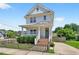 Charming two-story home with a inviting front porch and a beautifully landscaped yard on a sunny day at 309 S Haywood St St, Raleigh, NC 27601