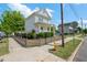 Street view of a two story home with white siding, a covered porch, and a cute picket fence at 309 S Haywood St St, Raleigh, NC 27601