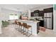 Open kitchen and living area with granite counters, stainless appliances, and barstool seating at 309 S Haywood St St, Raleigh, NC 27601
