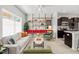 Bright living area with modern decor, open shelving, and an eat-in kitchen at 309 S Haywood St St, Raleigh, NC 27601