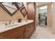 Elegant bathroom boasting dual sinks, wood cabinets, and a walk-in closet for ample storage at 31 River View Ct, Timberlake, NC 27583