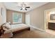 Comfortable bedroom featuring a cozy bed, window views, and access to an ensuite bathroom at 31 River View Ct, Timberlake, NC 27583
