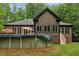 Back exterior view of home with a pool covered and an outdoor dining area with umbrella at 31 River View Ct, Timberlake, NC 27583