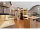 Open kitchen layout with custom cabinetry, granite countertops, and sleek black appliances at 31 River View Ct, Timberlake, NC 27583