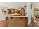 Eat-in kitchen island featuring a breakfast bar, custom wood finishes, and granite countertop at 31 River View Ct, Timberlake, NC 27583