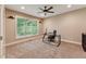 Bright office with a modern glass desk, carpeted floor, and large window offering natural light and greenery views at 31 River View Ct, Timberlake, NC 27583
