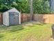 Well-maintained backyard featuring a storage shed, green lawn, and privacy fence at 312 Crusaders Dr, Morrisville, NC 27560