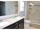 Bathroom features double sinks with granite counters and a glass enclosed tiled shower at 312 Crusaders Dr, Morrisville, NC 27560