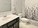 Bathroom with single vanity, toilet and tub with patterned shower curtain at 312 Crusaders Dr, Morrisville, NC 27560