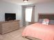 Bedroom with carpet, a bed with an upholstered headboard, and a TV on a dresser at 312 Crusaders Dr, Morrisville, NC 27560