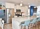 Modern kitchen with white cabinets, stainless steel appliances, granite countertops, and a stylish island with seating at 312 Crusaders Dr, Morrisville, NC 27560