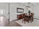 Elegant dining area with a modern light fixture and views of the living spaces at 337 Brinkley Cir, Mebane, NC 27302
