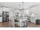 Bright and spacious kitchen with white cabinets, stainless steel appliances, and granite countertops at 337 Brinkley Cir, Mebane, NC 27302