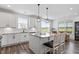 Bright kitchen features white cabinets, an island with bar seating, granite countertops, and stainless steel appliances at 337 Brinkley Cir, Mebane, NC 27302