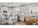 Well-lit kitchen with granite countertops, stainless steel appliances, and a central island with bar seating at 337 Brinkley Cir, Mebane, NC 27302
