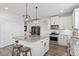 Bright and spacious kitchen with white cabinets, stainless steel appliances, and granite countertops at 337 Brinkley Cir, Mebane, NC 27302
