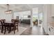 Open-concept dining area and living room featuring hardwood floors and coffered ceilings at 337 Brinkley Cir, Mebane, NC 27302