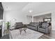 Open-concept living room with stylish furniture, a fireplace, and seamless transition to the dining area at 337 Brinkley Cir, Mebane, NC 27302