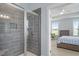 Modern main bathroom featuring a glass enclosed shower with tiled walls and an entrance into the main bedroom at 337 Brinkley Cir, Mebane, NC 27302