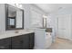 Elegant bathroom with soaking tub, gray cabinetry, separate vanities, and ceramic tile flooring at 337 Brinkley Cir, Mebane, NC 27302