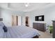 Spacious main bedroom features tray ceilings, a ceiling fan, and a wall mounted television at 337 Brinkley Cir, Mebane, NC 27302