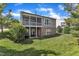 Backyard view showcasing a screened porch, manicured lawn, and the home's back exterior with a walkout basement at 3400 Secretariat Way, Raleigh, NC 27614