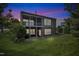 Backyard view showcasing a screened porch, manicured lawn, and the home's back exterior with a walkout basement at twilight at 3400 Secretariat Way, Raleigh, NC 27614