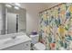 This bathroom offers a vanity, mirror, toilet, and floral shower curtain at 3400 Secretariat Way, Raleigh, NC 27614