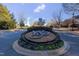 Landscaped entrance to community with signage and colorful flowers at 3400 Secretariat Way, Raleigh, NC 27614