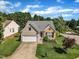 Charming home featuring a well-maintained yard, attached garage, and classic architectural details under a bright sky at 3400 Secretariat Way, Raleigh, NC 27614