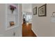 Hallway view with art niches and hardwood floors leads to bright living spaces at 3400 Secretariat Way, Raleigh, NC 27614