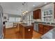 Bright kitchen featuring stainless steel appliances, dark cabinets, and granite countertops at 3400 Secretariat Way, Raleigh, NC 27614