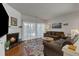 Inviting living room with a cozy fireplace, wood floors, and bright natural light from the sliding glass doors at 3400 Secretariat Way, Raleigh, NC 27614