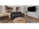 Inviting living room with an open floorplan and view of the kitchen, featuring wood floors and comfortable seating at 3400 Secretariat Way, Raleigh, NC 27614