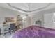Bright main bedroom features a tray ceiling, a functional desk area, and an ensuite bath at 3400 Secretariat Way, Raleigh, NC 27614