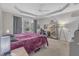 Bright main bedroom features a tray ceiling, large window, and a functional desk area at 3400 Secretariat Way, Raleigh, NC 27614
