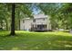 Backyard showcasing a screened deck, patio and spacious, well-maintained lawn at 353 Spearhead Pl, Clayton, NC 27520