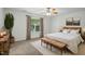 Bedroom with neutral decor, featuring a wooden bench, a leafy plant, and natural light at 353 Spearhead Pl, Clayton, NC 27520