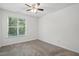 Bright bedroom featuring a ceiling fan and a window that provides natural light at 353 Spearhead Pl, Clayton, NC 27520